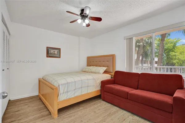 a bedroom with a bed couch and window