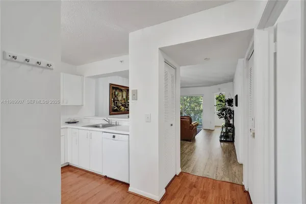 a view of a kitchen from a hallway