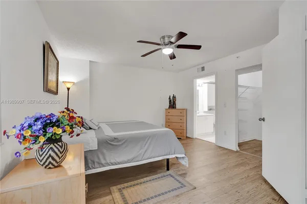 a bedroom with a bed and dresser