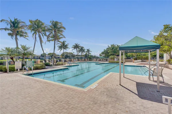 a swimming pool with outdoor seating and yard