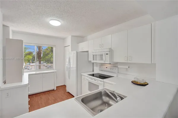 a kitchen that has a sink and a stove