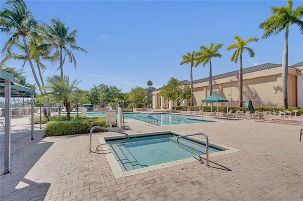 a view of swimming pool with outdoor seating and plants