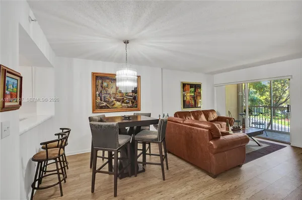 a living room with furniture two window and wooden floor