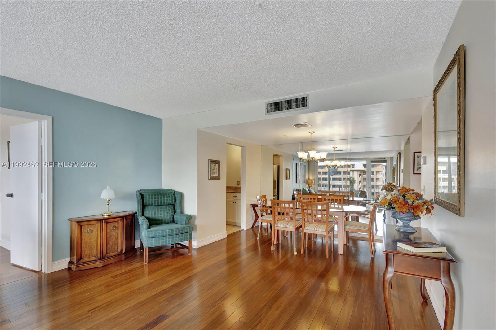 336 Golfview Road, Unit 311 North Palm Beach, FL 33408 - Photo 11 of 62 a view of a dining room with furniture wooden floor and a chandelier