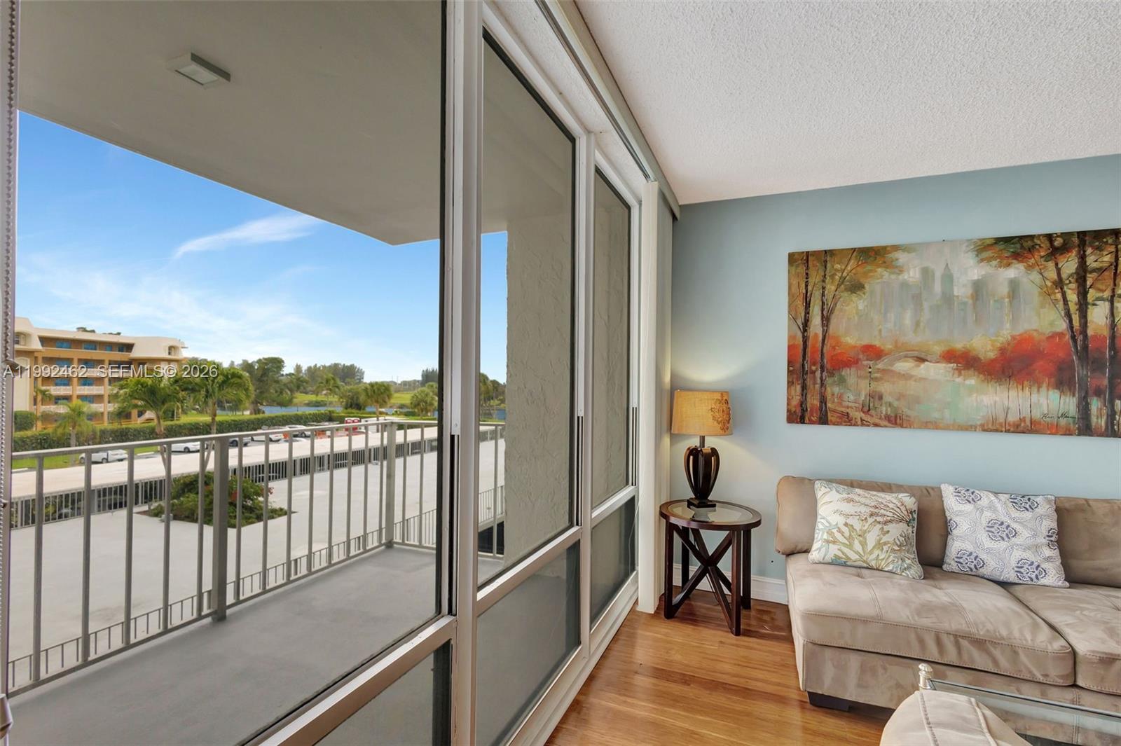 336 Golfview Road, Unit 311 North Palm Beach, FL 33408 - Photo 14 of 62 a living room with furniture and a painting on the wall