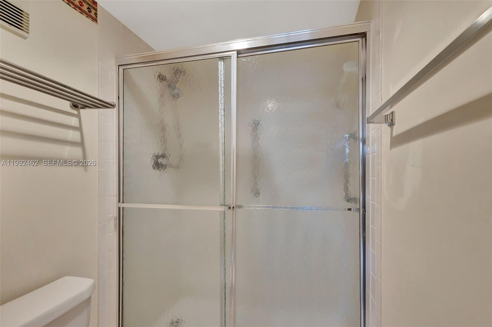 336 Golfview Road, Unit 311 North Palm Beach, FL 33408 - Photo 26 of 62 a bathroom with a glass shower door