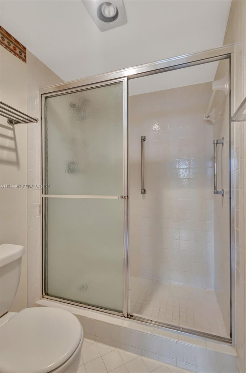 336 Golfview Road, Unit 311 North Palm Beach, FL 33408 - Photo 27 of 62 a white toilet sitting next to a shower