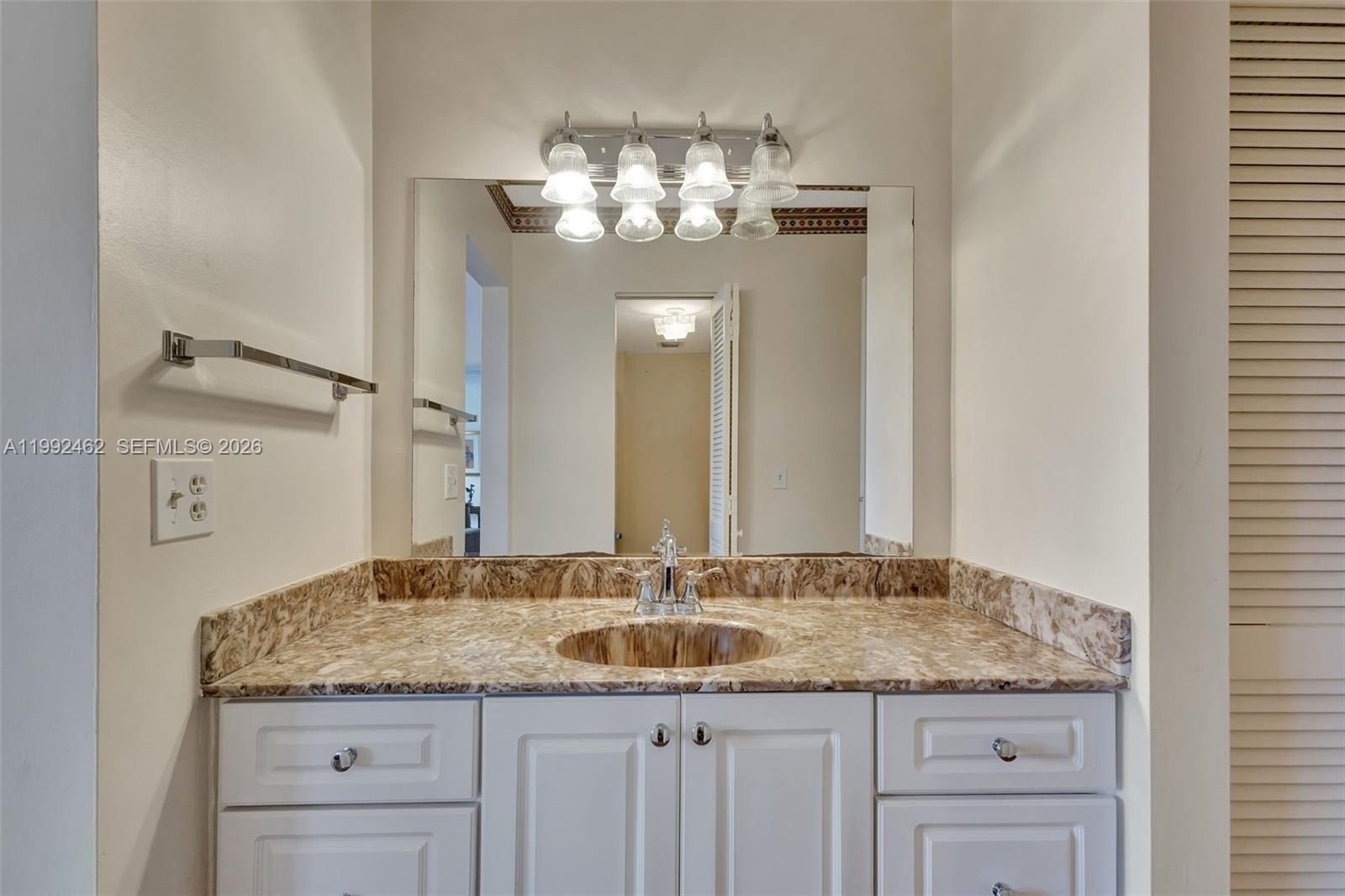 336 Golfview Road, Unit 311 North Palm Beach, FL 33408 - Photo 28 of 62 a bathroom with a granite countertop sink and a mirror