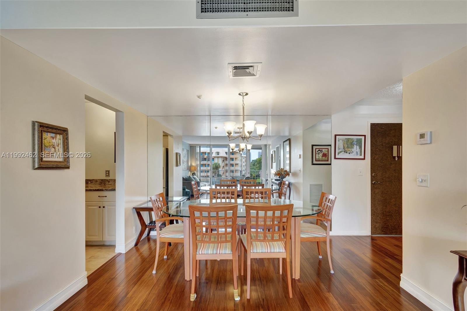 336 Golfview Road, Unit 311 North Palm Beach, FL 33408 - Photo 3 of 62 a view of a dining room with furniture and wooden floor