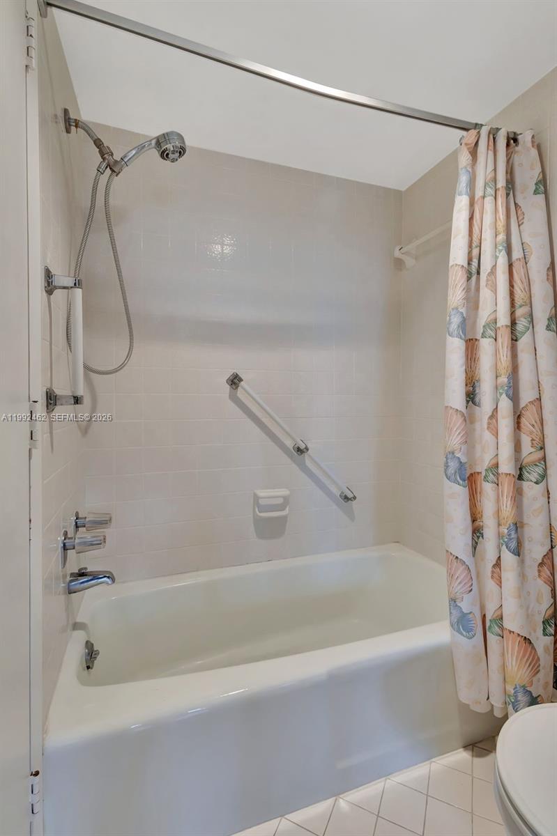 336 Golfview Road, Unit 311 North Palm Beach, FL 33408 - Photo 34 of 62 a bathroom with a bathtub and a shower