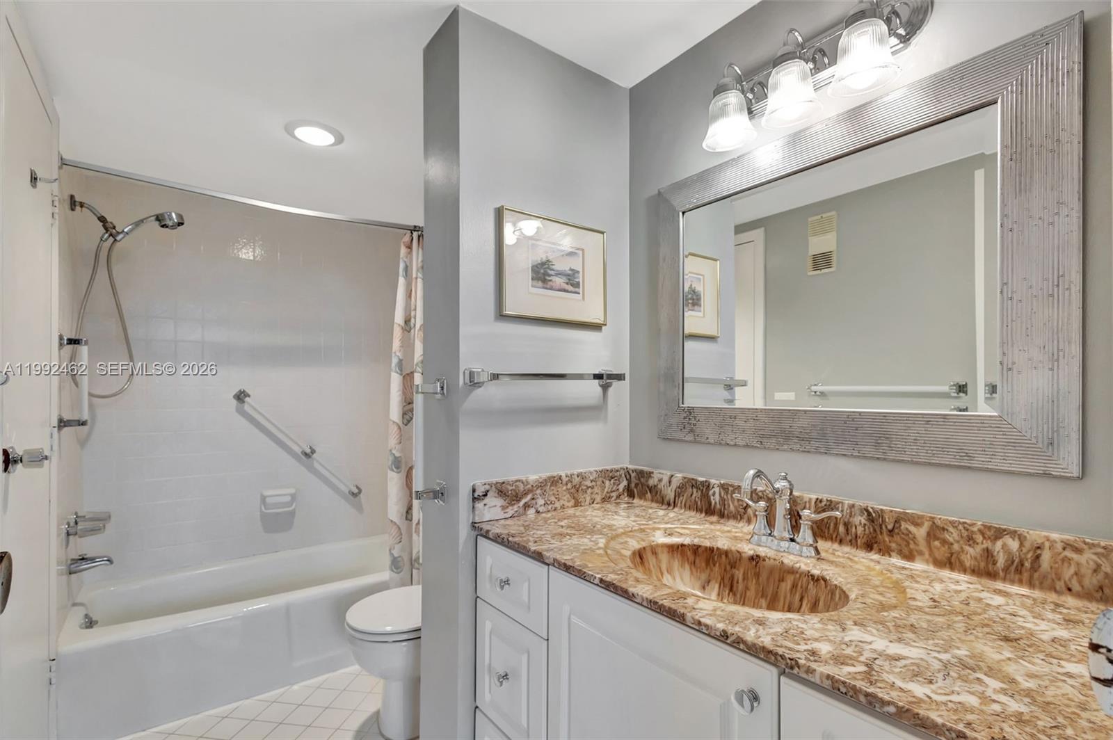 336 Golfview Road, Unit 311 North Palm Beach, FL 33408 - Photo 35 of 62 a bathroom with a granite countertop sink mirror toilet and bathtub