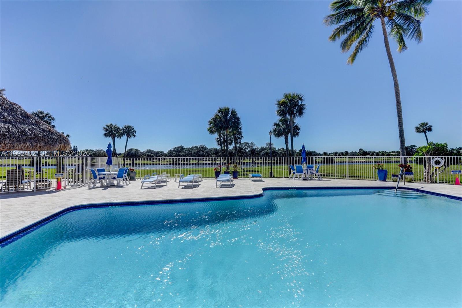 336 Golfview Road, Unit 311 North Palm Beach, FL 33408 - Photo 50 of 62 a view of swimming pool with a yard and palm trees