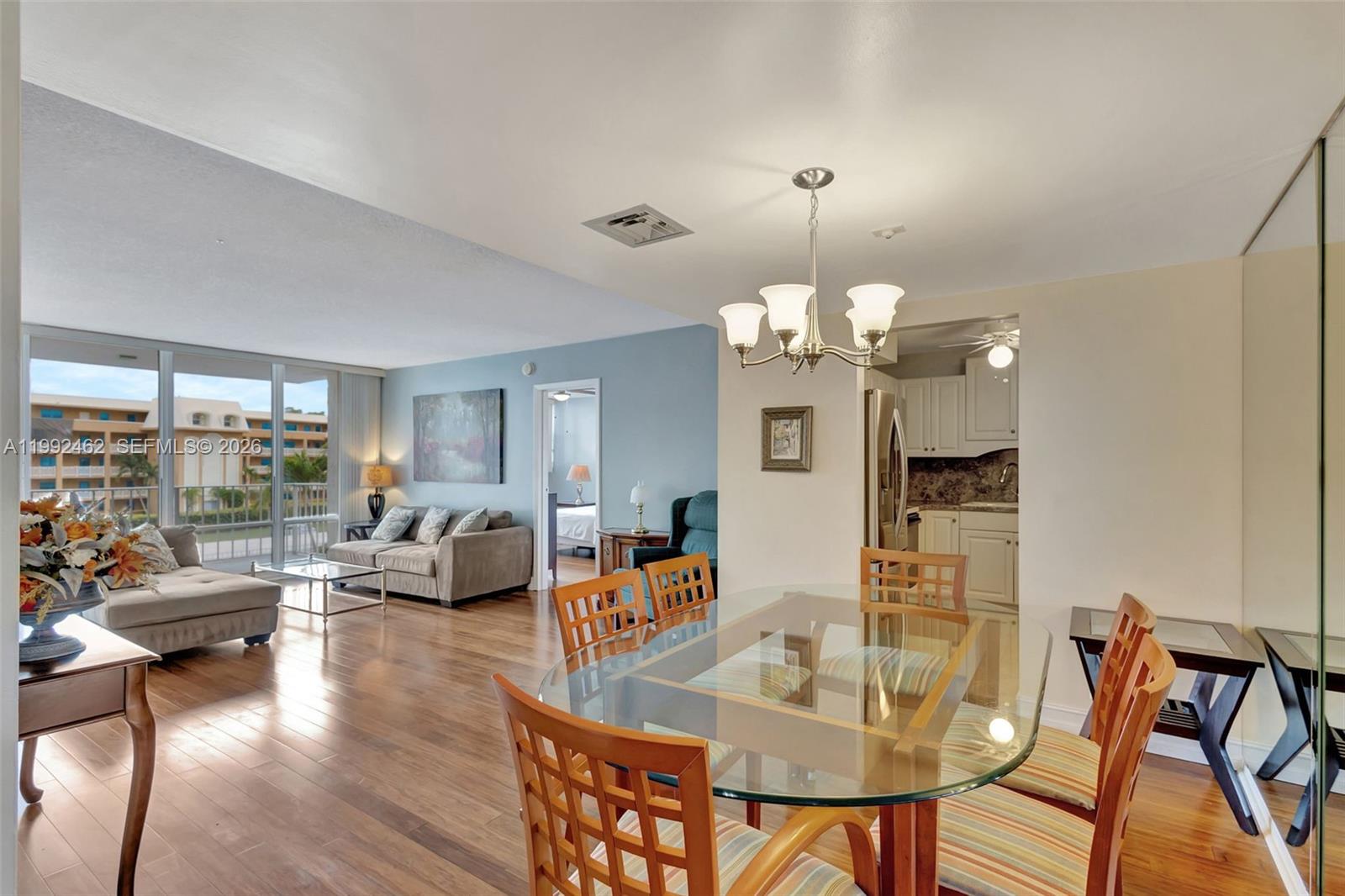 336 Golfview Road, Unit 311 North Palm Beach, FL 33408 - Photo 5 of 62 a living room with dining table and a chandelier