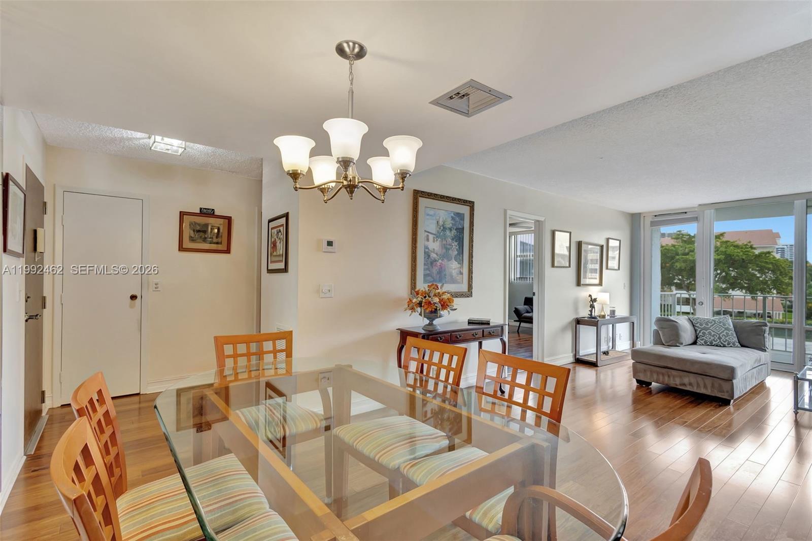 336 Golfview Road, Unit 311 North Palm Beach, FL 33408 - Photo 8 of 62 a living room with furniture chandelier and a large mirror