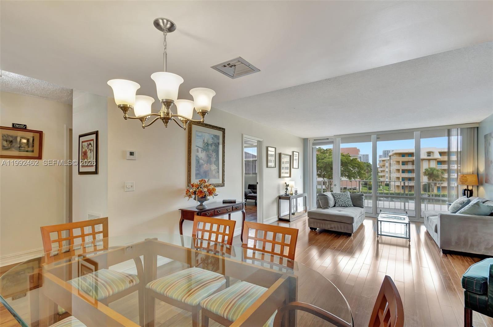 336 Golfview Road, Unit 311 North Palm Beach, FL 33408 - Photo 9 of 62 a view of a dining room with furniture wooden floor and chandelier