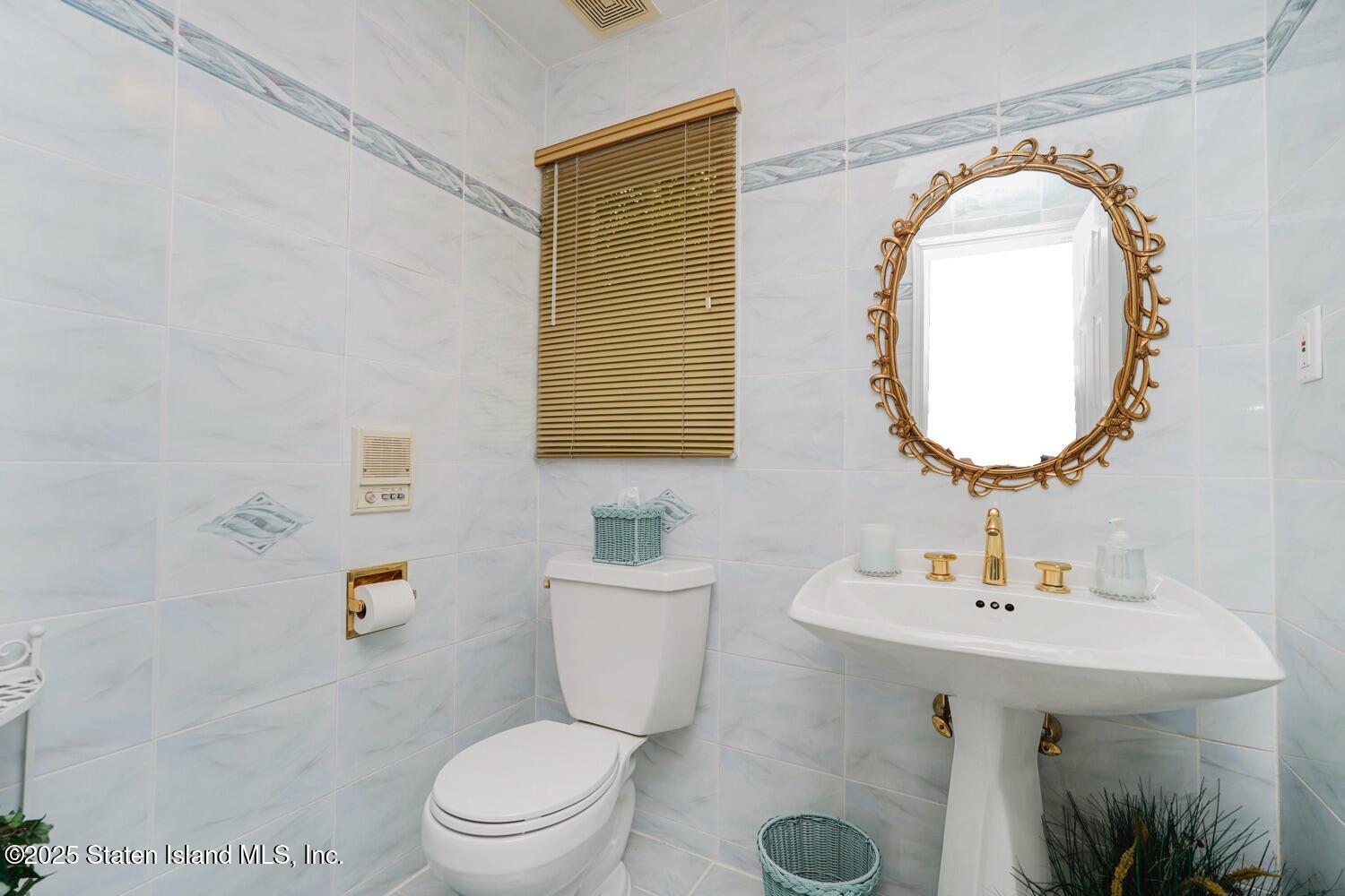 312 Barbara Street Staten Island, NY 10306 - Photo 13 of 34 a bathroom with a toilet sink and mirror