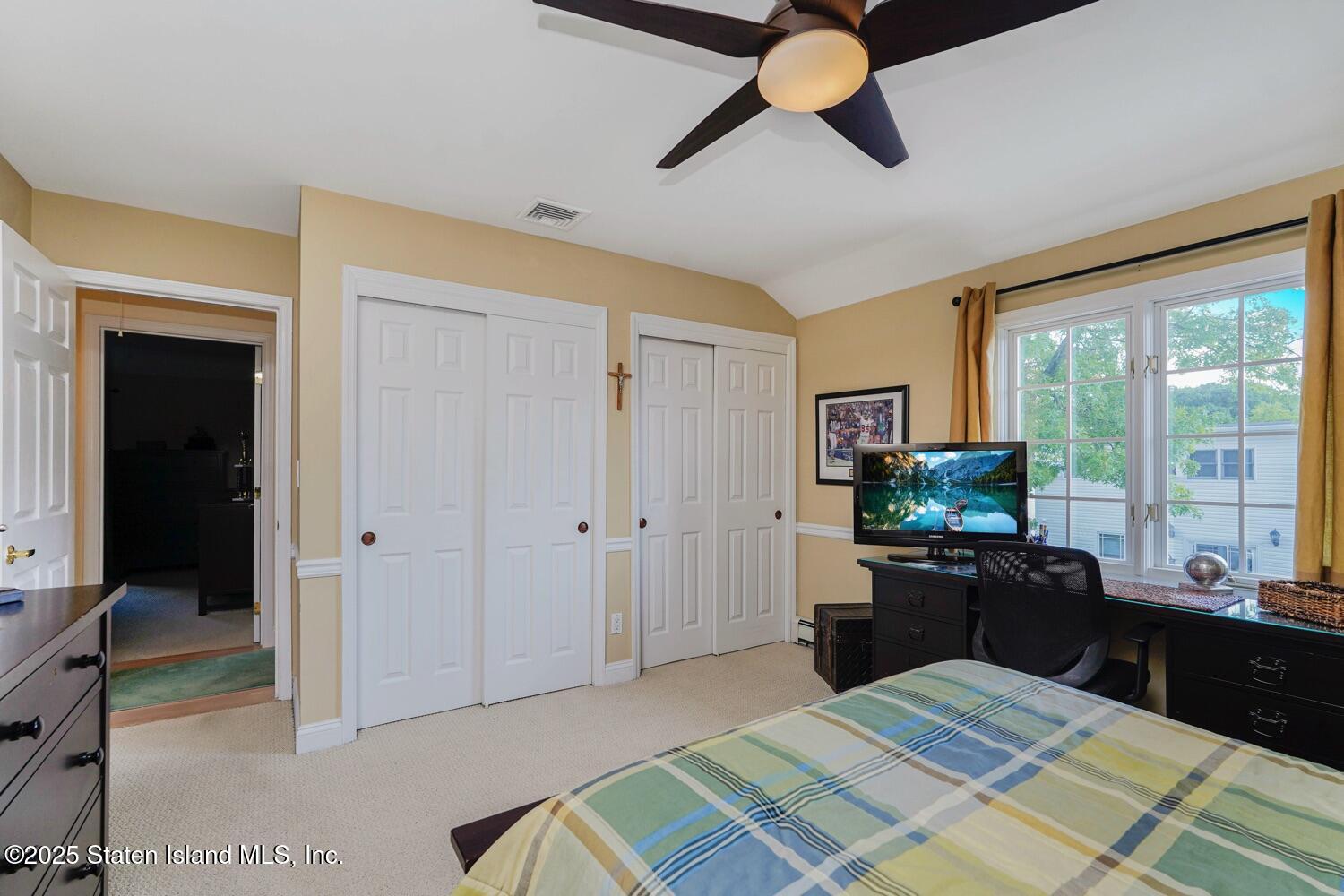 312 Barbara Street Staten Island, NY 10306 - Photo 19 of 34 a bedroom with a bed and a chandelier