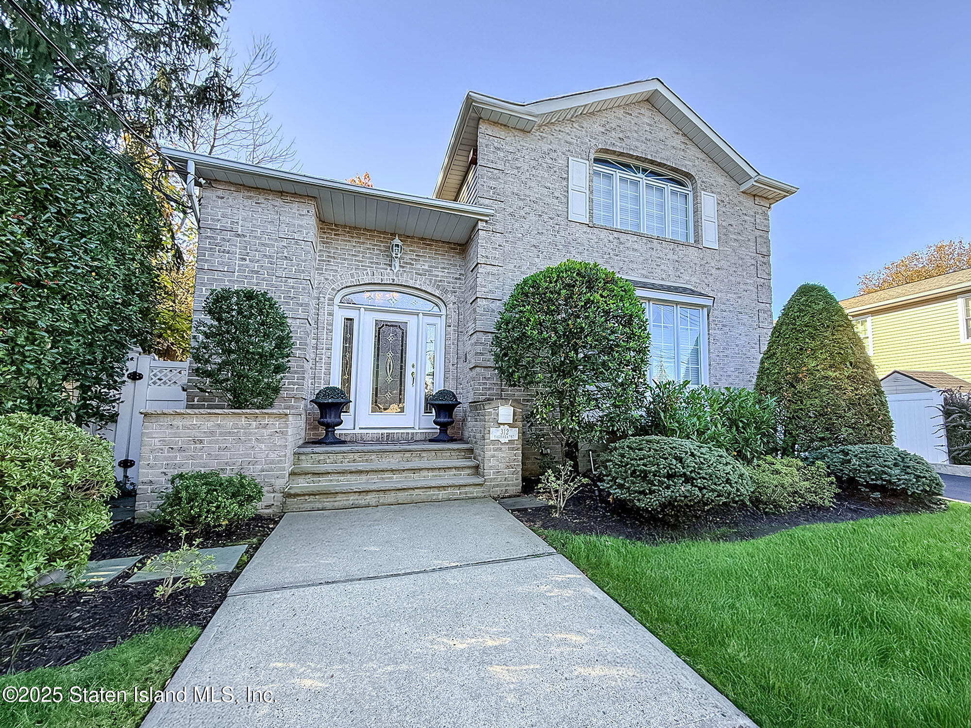 312 Barbara Street Staten Island, NY 10306 - Photo 2 of 34 a front view of a house with a garden