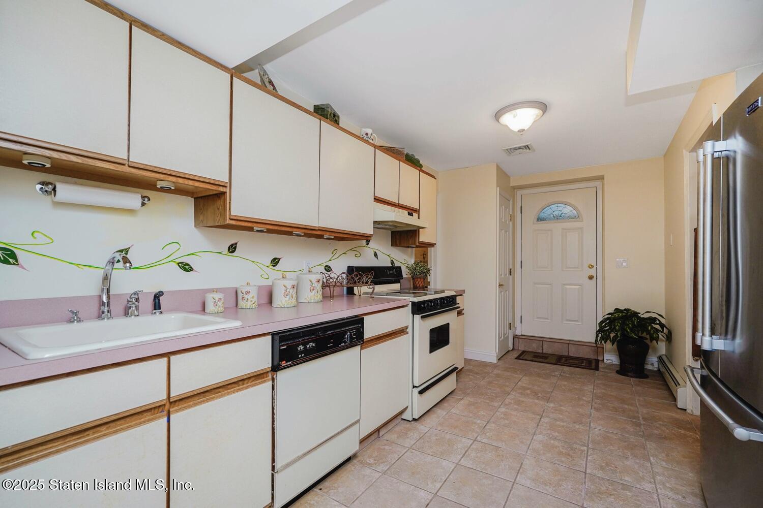 312 Barbara Street Staten Island, NY 10306 - Photo 25 of 34 a kitchen with a sink cabinets and appliances