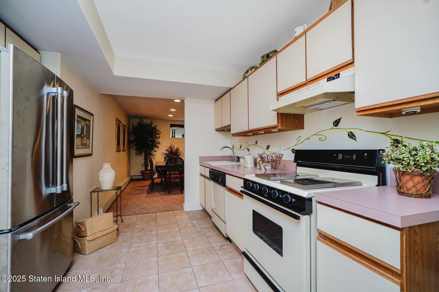 312 Barbara Street Staten Island, NY 10306 - Photo 26 of 34 a kitchen with stainless steel appliances a stove a sink and a refrigerator