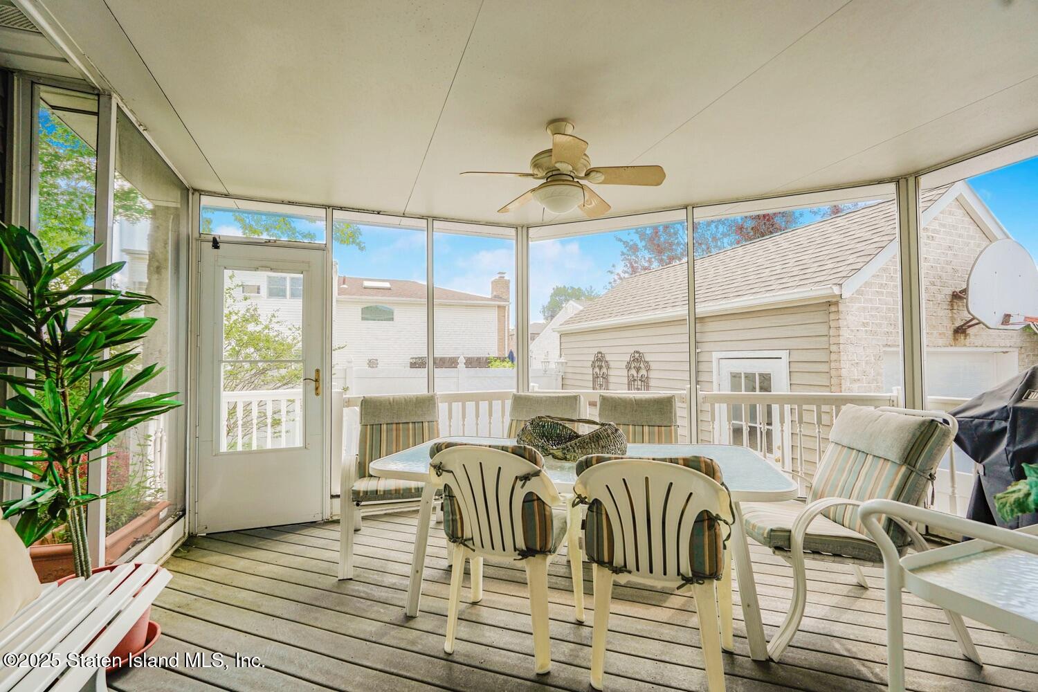 312 Barbara Street Staten Island, NY 10306 - Photo 30 of 34 a view of a dining room with furniture large windows and wooden floor
