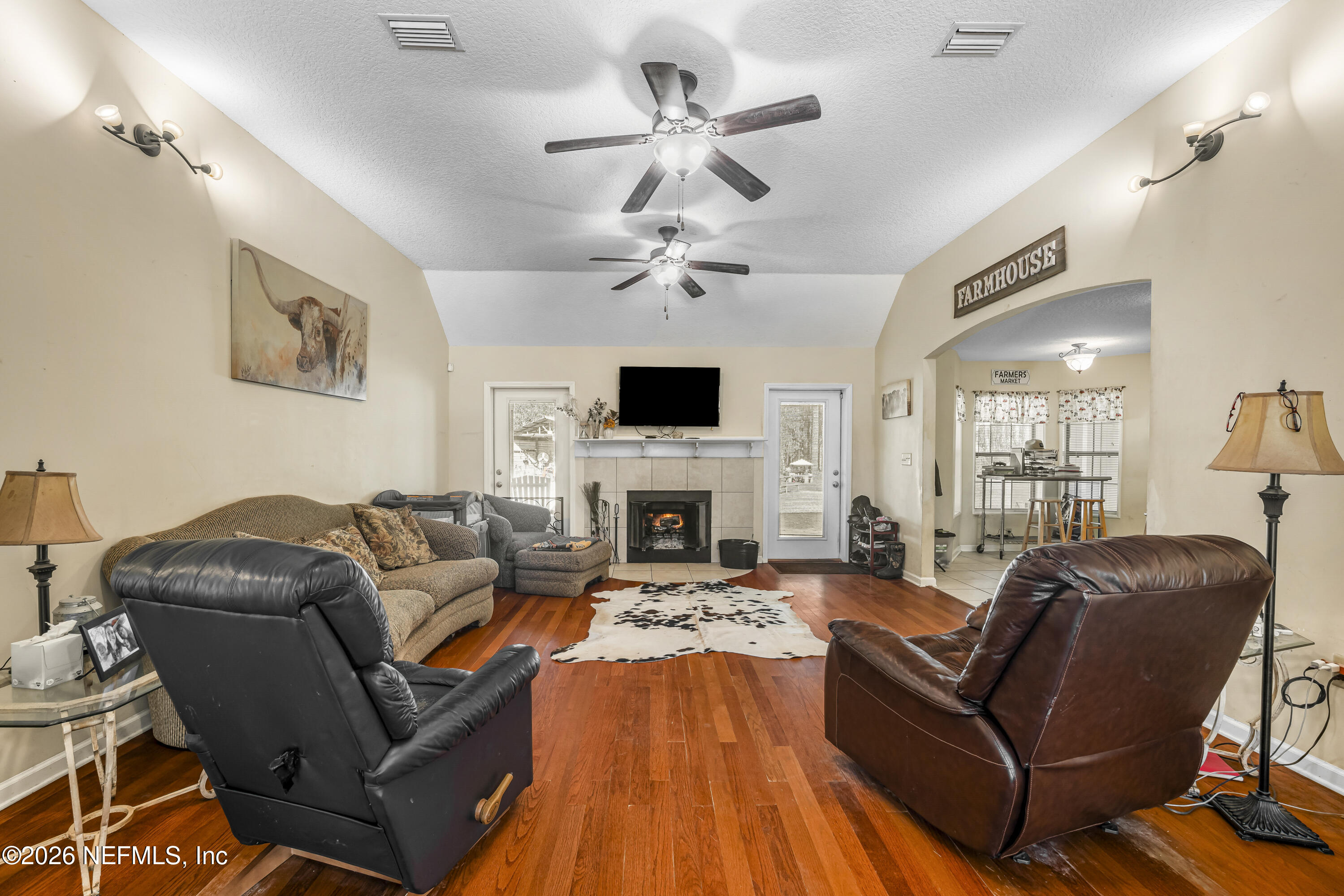 1725 Davidson Farm Road Jacksonville, FL 32218 - Photo 2 of 53 a living room with furniture a fireplace and a ceiling fan
