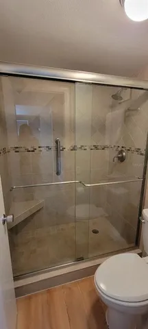 a living room with furniture a flat screen tv and a large window