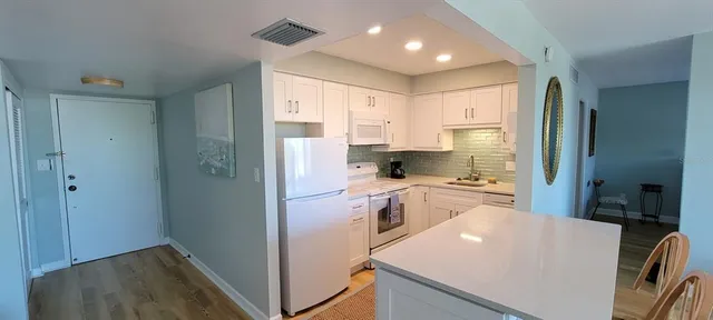 a bedroom with a bed table and a window