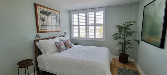 a kitchen with a refrigerator a stove and a microwave with wooden floor
