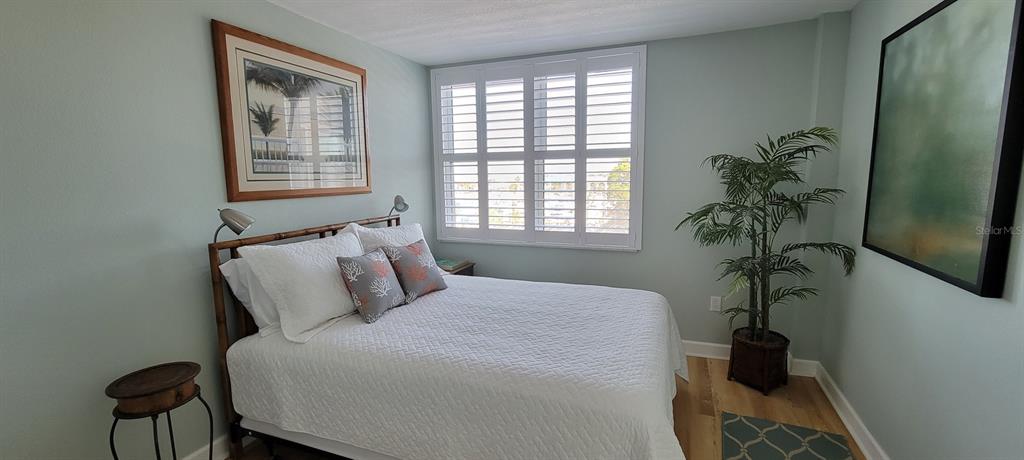 632 Edgewater Drive, Unit 537 Dunedin, FL 34698 - Photo 15 of 28 a bedroom with a bed table and a window