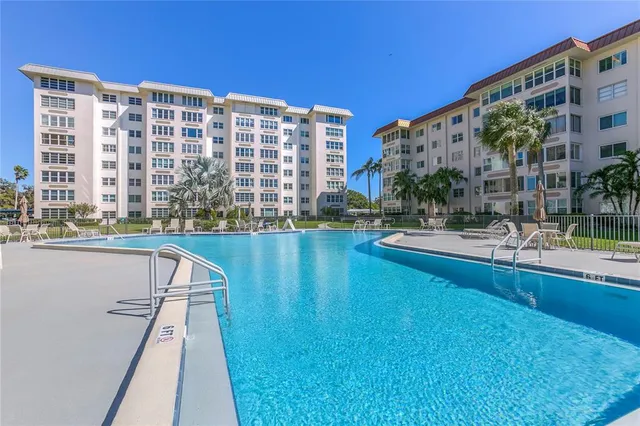 a view of building with yard and swimming pool