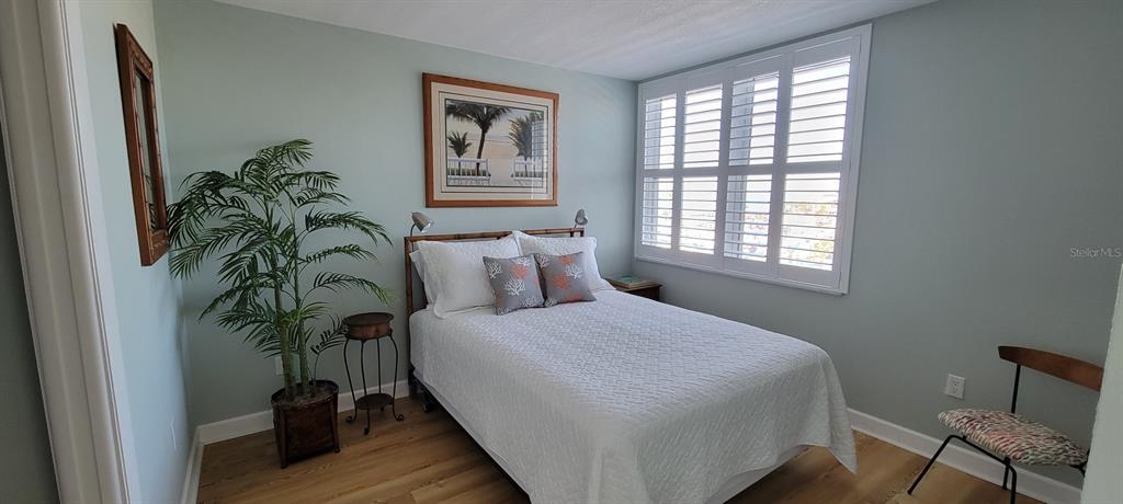 632 Edgewater Drive, Unit 537 Dunedin, FL 34698 - Photo 6 of 28 a bedroom with a bed table closet and a window