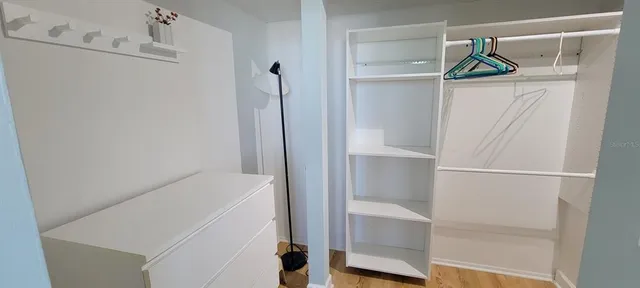 a spacious bathroom with a granite countertop sink and a mirror