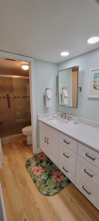 632 Edgewater Drive, Unit 537 Dunedin, FL 34698 - Photo 8 of 28 a spacious bathroom with a granite countertop sink and a mirror