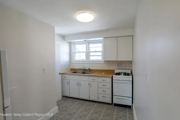 a view of a kitchen with sink cabinets and window