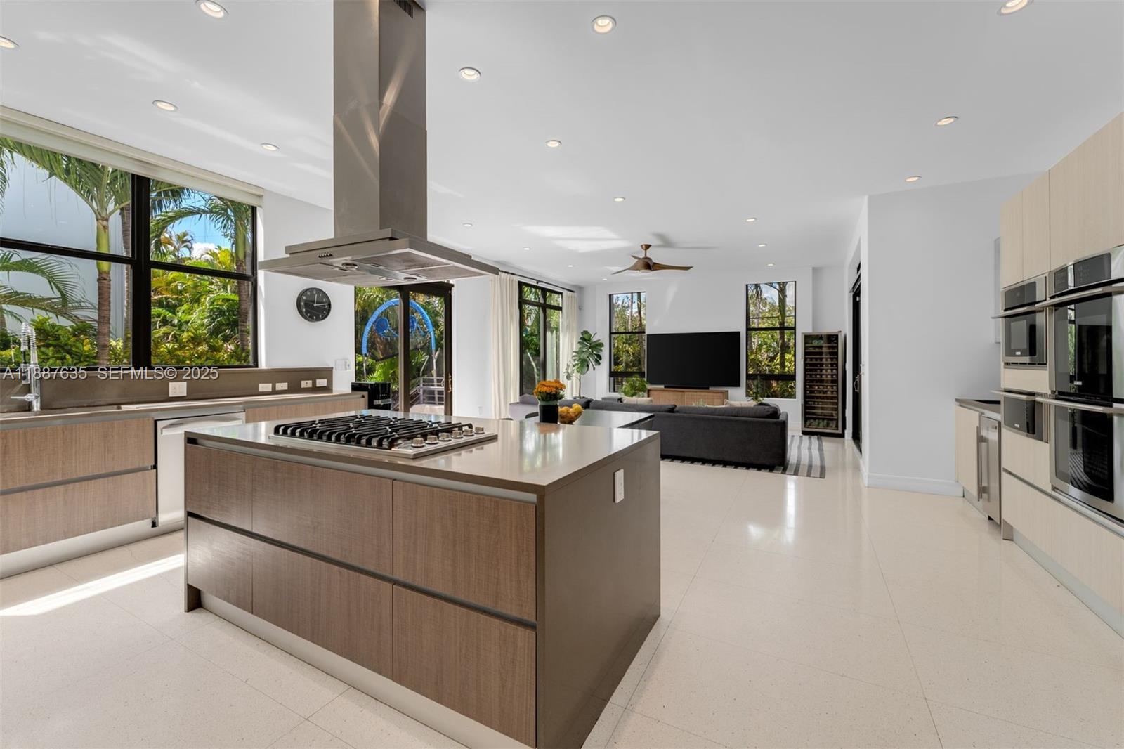 330 Caribbean Road Key Biscayne, FL 33149 - Photo 13 of 46 a kitchen with stainless steel appliances a white stove top oven a sink and a refrigerator