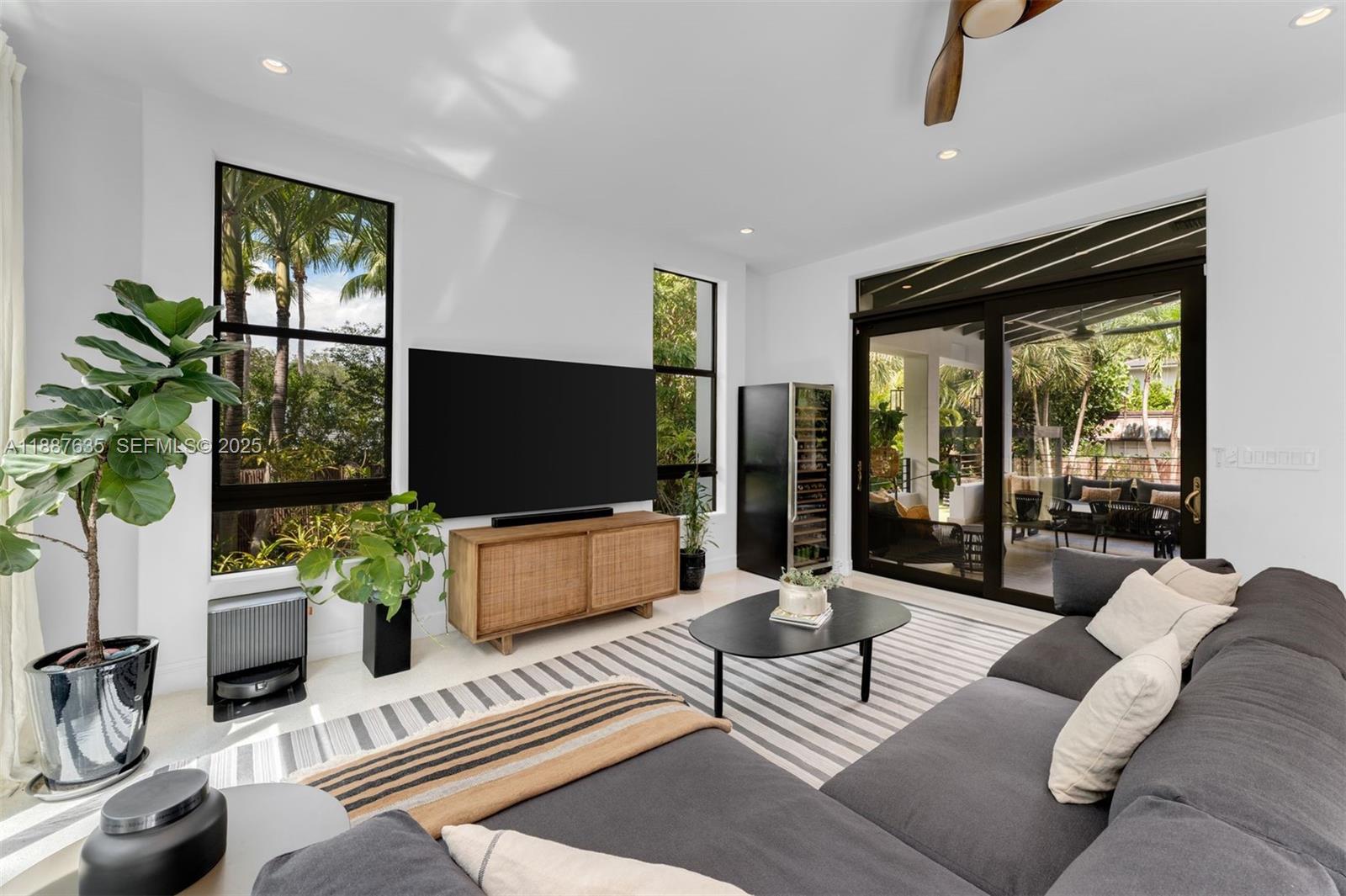 330 Caribbean Road Key Biscayne, FL 33149 - Photo 15 of 46 a living room with furniture a flat screen tv and a large window