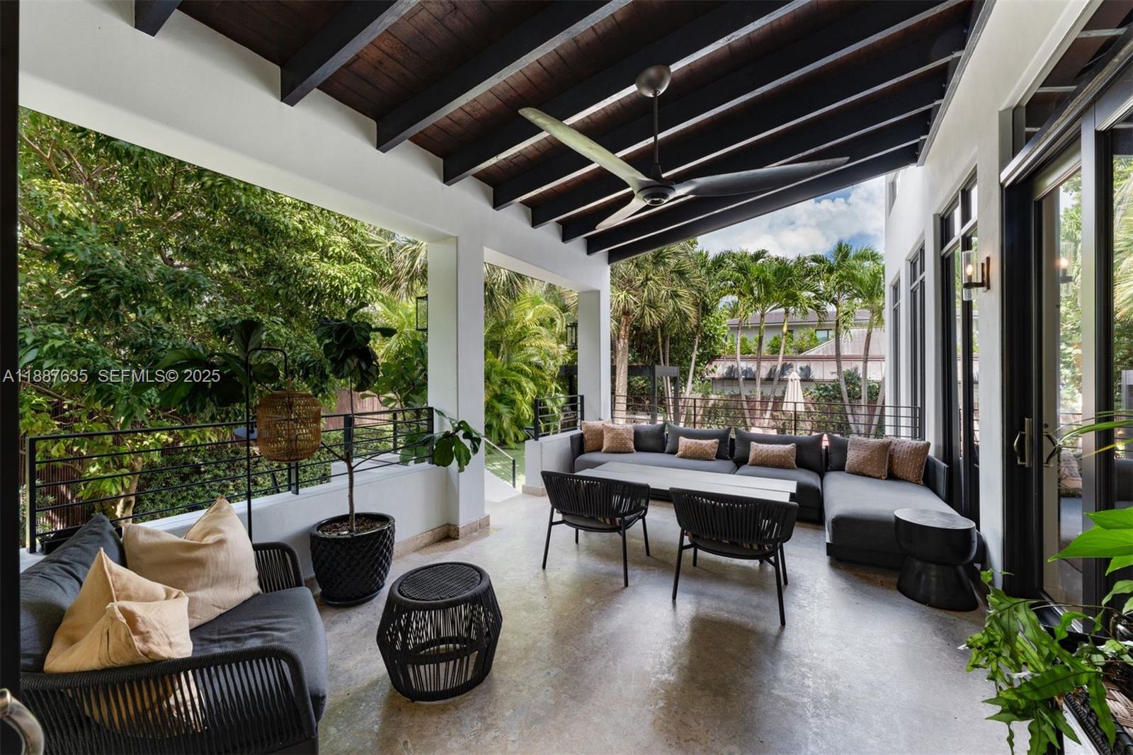 330 Caribbean Road Key Biscayne, FL 33149 - Photo 16 of 46 a living room with patio furniture and a potted plants