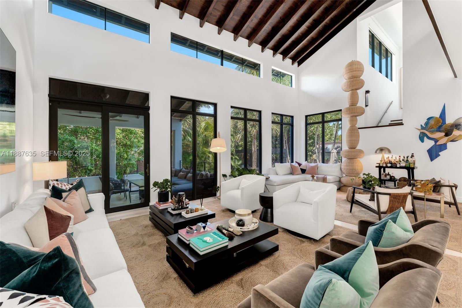 330 Caribbean Road Key Biscayne, FL 33149 - Photo 4 of 46 a living room with furniture fireplace and large windows