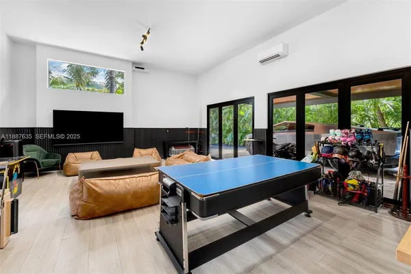 a living room with furniture gym equipment and a flat screen tv