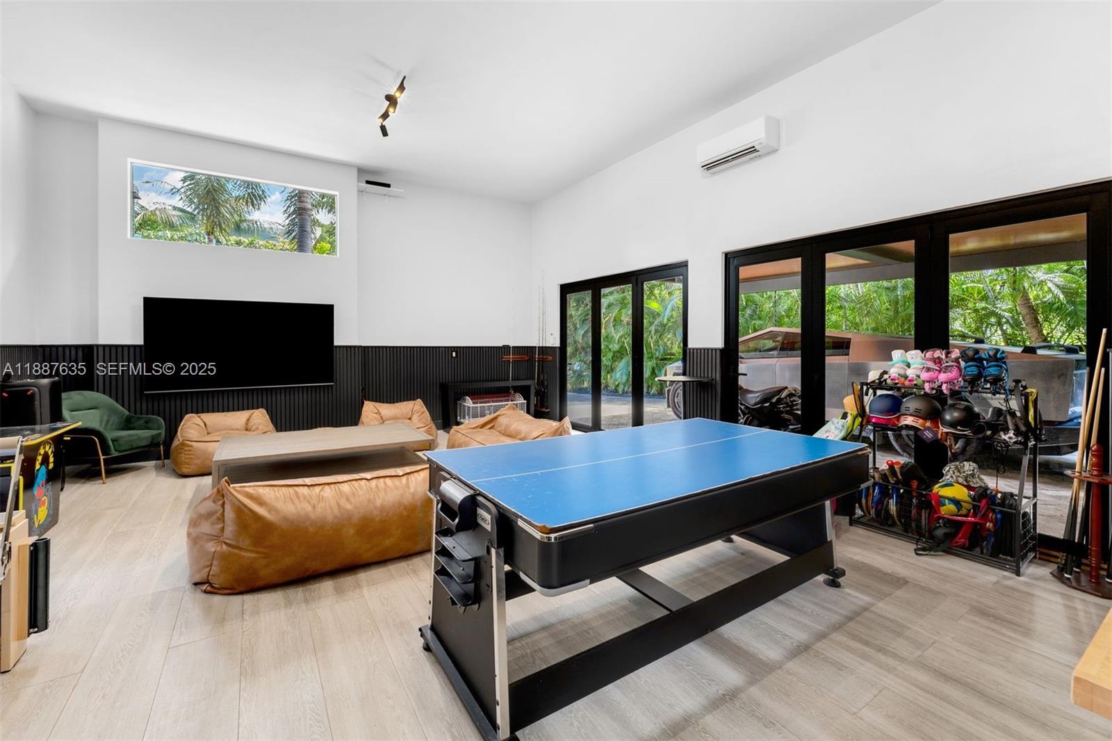 330 Caribbean Road Key Biscayne, FL 33149 - Photo 41 of 46 a room with furniture pool table flat screen tv and a large window