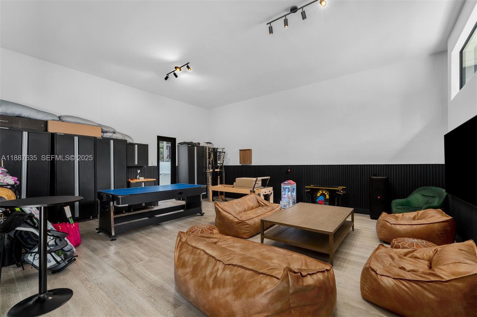 330 Caribbean Road Key Biscayne, FL 33149 - Photo 42 of 46 a living room with furniture gym equipment and a flat screen tv