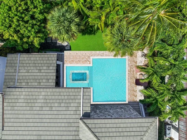 an aerial view of multiple houses with yard