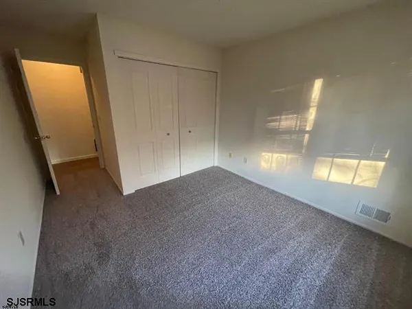 a view of an empty room and a window