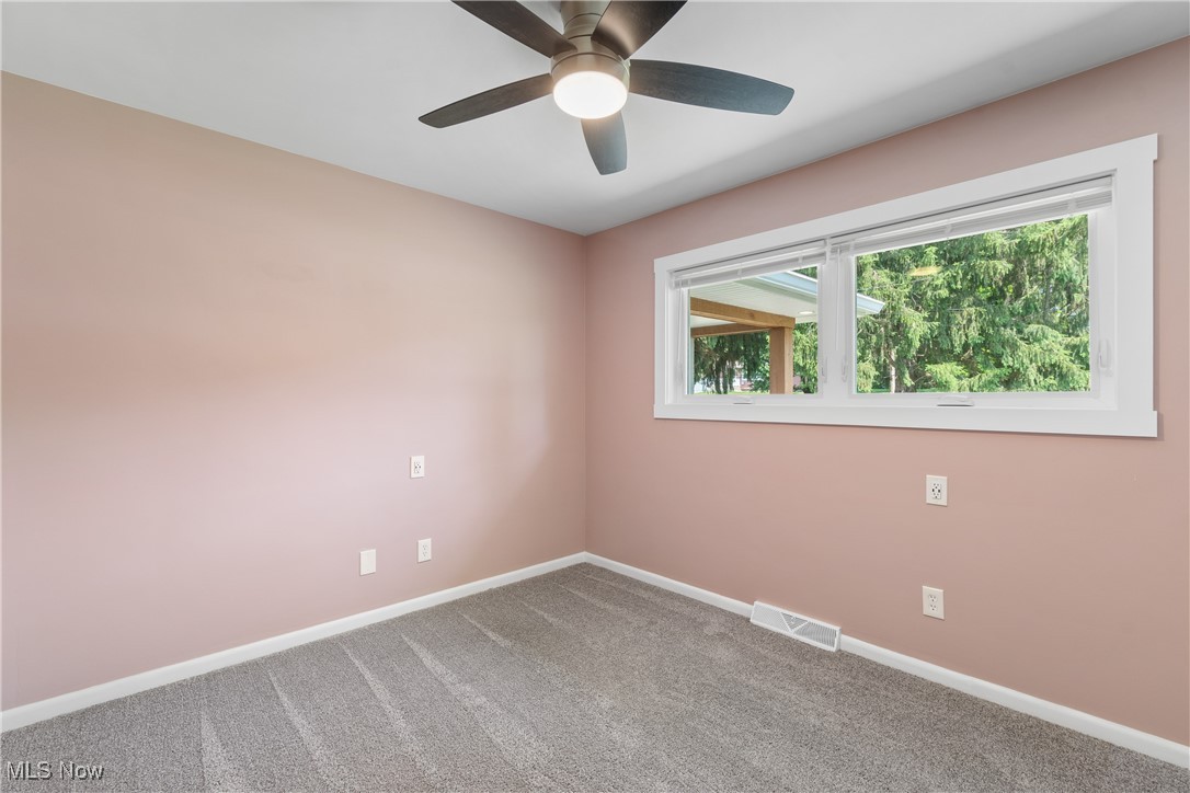 1892 Toepfer Road Akron, OH 44312 - Photo 19 of 34 Carpeted spare room with baseboards and a ceiling fan