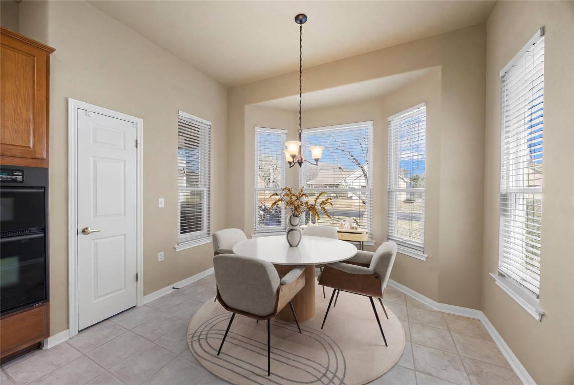 104 Lariat Drive Georgetown, TX 78633 - Photo 11 of 35 a dining room with furniture a chandelier and window
