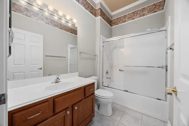 a view of an empty room and chandelier fan