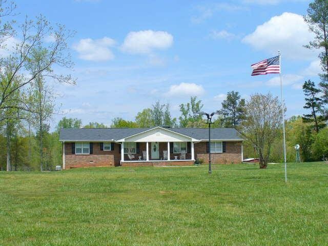 1958 Flat Rock Road Stockbridge, GA 30281 - Photo 1 of 1 a front view of a house with a garden