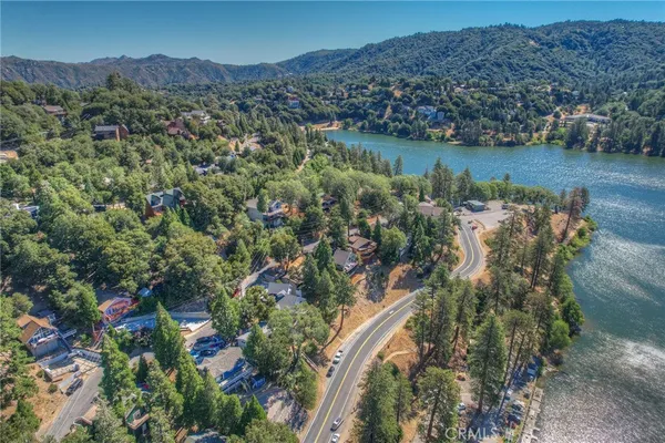 an aerial view of a houses with a lake