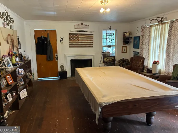 a bed sitting in a spacious bedroom next to a window